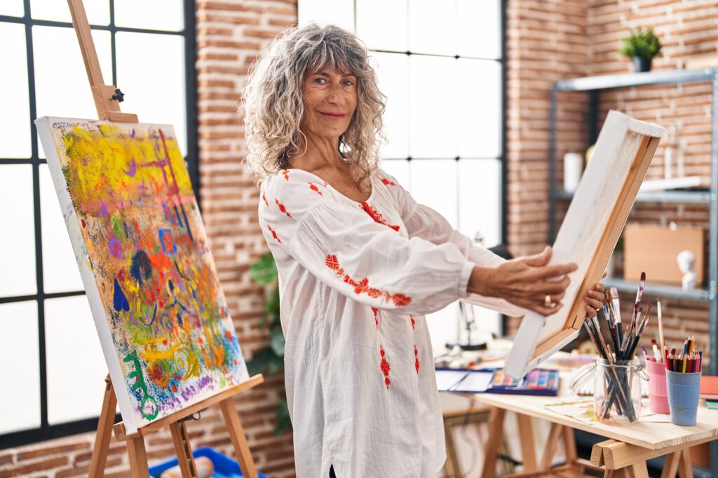 middle age woman artist looking draw at art studio middle age woman artist looking draw at art studio